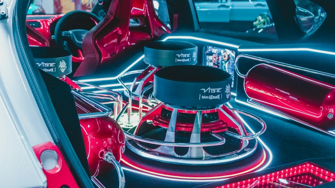 Custom car audio system with subwoofers and red air tanks.